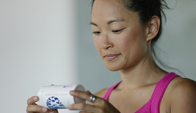 Woman checking supplement label