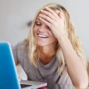 Blonde woman with laptop forget something buy in online store, facepalm