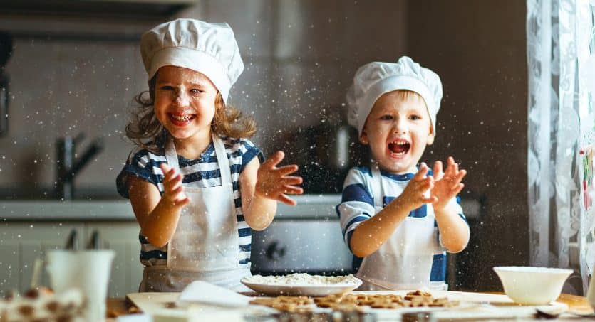 happy family funny kids are preparing the dough, bake cookies in the kitchen