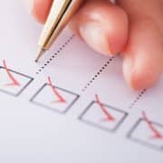 Cropped image of businesswoman writing on checklist