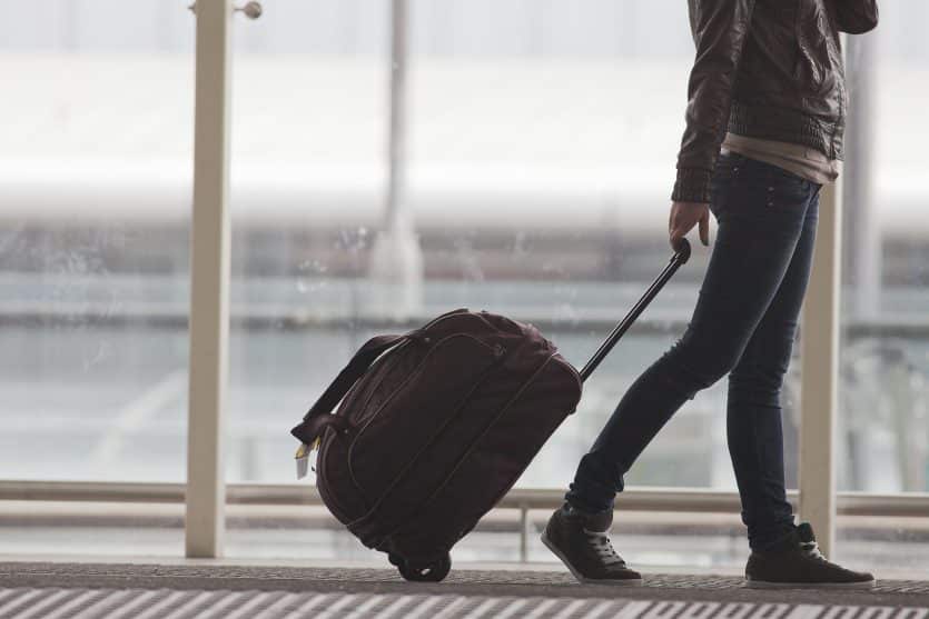 Woman carries your luggage at the airport terminal of Hong Kong