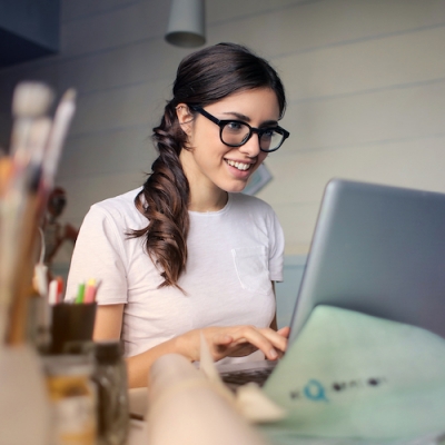 image of smart beautiful woman sitting at computer smiling