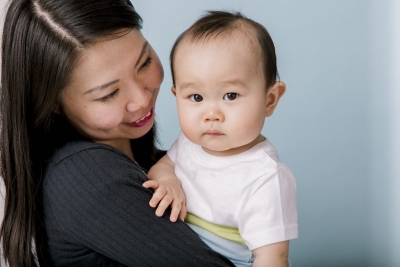 mother holding baby in her arms