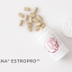 EstroPro bottle with pills spilling out of bottle on white marble