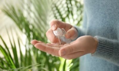 Woman using antibacterial hand sanitizer