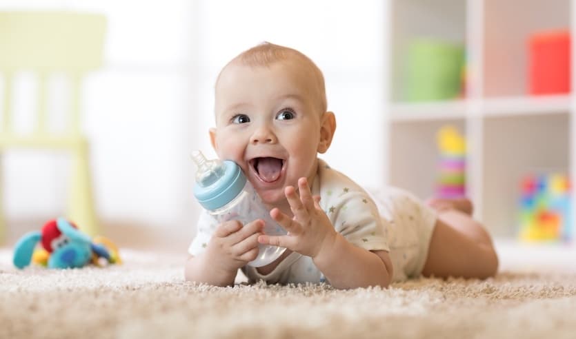 Cute baby boy drinking from bottle