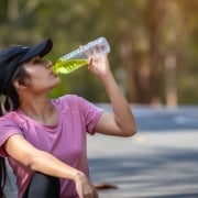 woman athlete drinking water with electrolytes