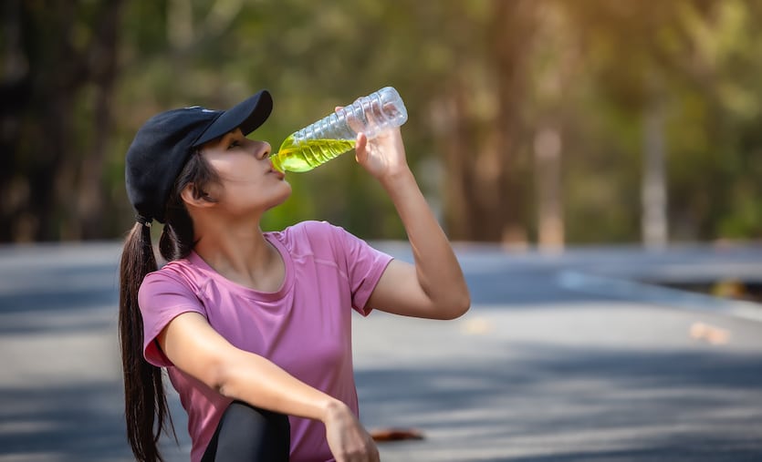 woman athlete drinking water with electrolytes