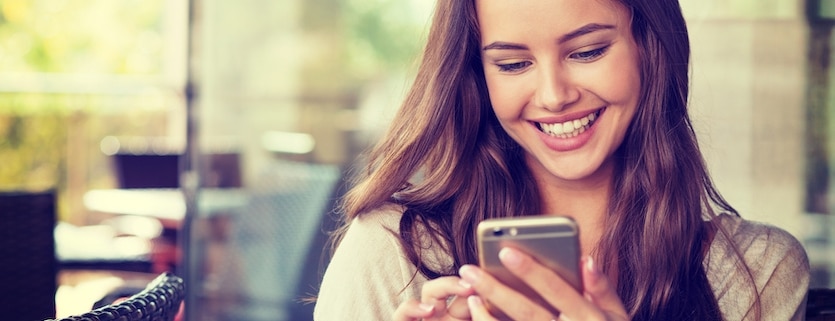 woman in cafe using her mobile phone